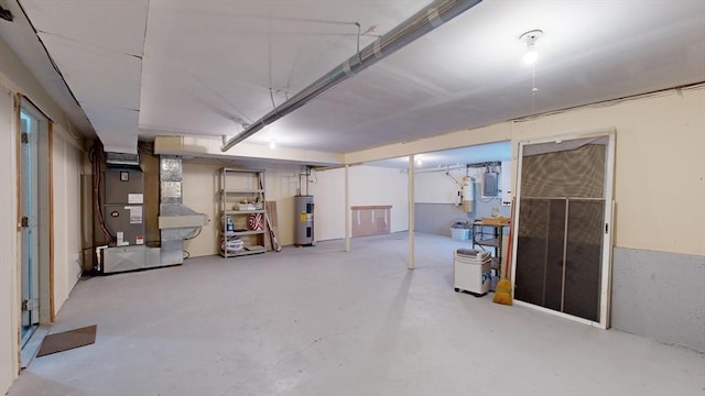 basement featuring electric panel, electric water heater, and heating unit