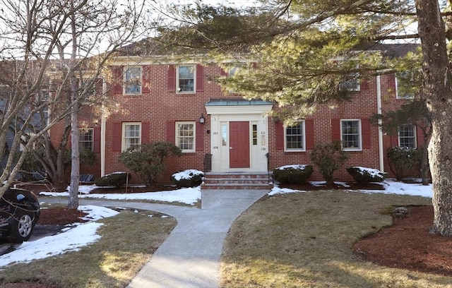 colonial inspired home with a yard