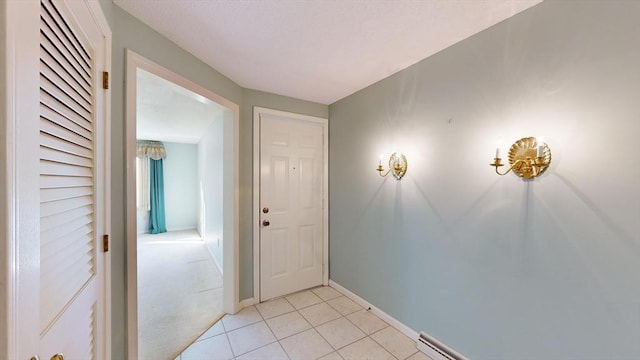 hall with light tile patterned floors