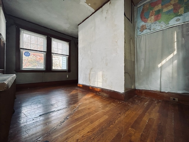 empty room with dark hardwood / wood-style flooring