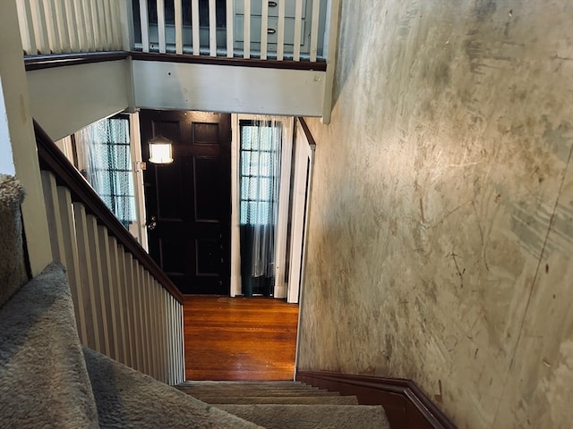 stairs with hardwood / wood-style floors