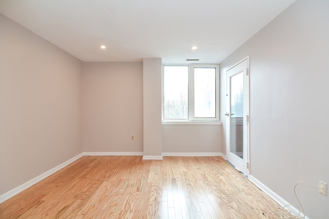 spare room featuring light hardwood / wood-style floors