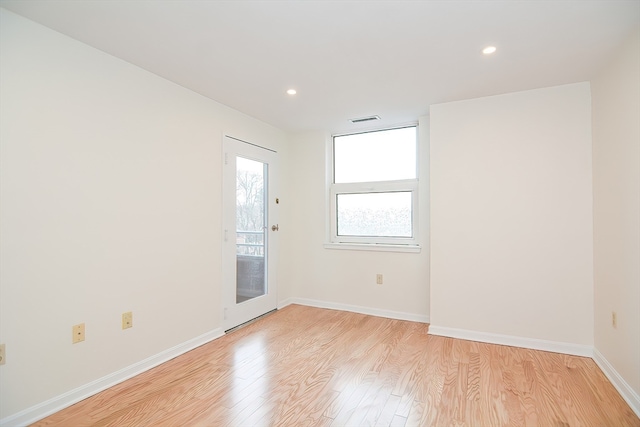 spare room featuring light hardwood / wood-style flooring