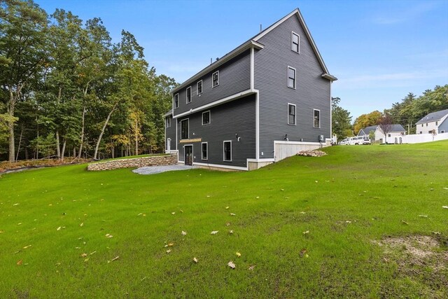 back of house with a yard and a patio area