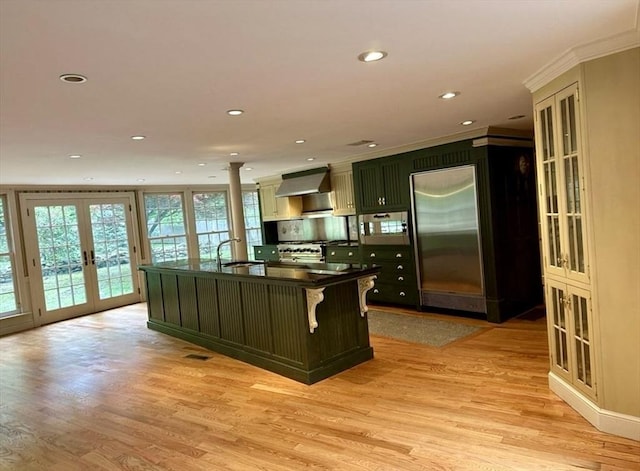 14 Alderbrook Dr, Topsfield, MA 01983 - kitchen featuring french doors, dark countertops, appliances with stainless steel finishes, light wood-type flooring, and exhaust hood