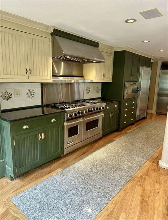 14 Alderbrook Dr, Topsfield, MA 01983 - kitchen with double oven range, green cabinets, range hood, dark countertops, and tasteful backsplash