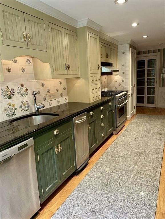 14 Alderbrook Dr, Topsfield, MA 01983 - kitchen with appliances with stainless steel finishes, green cabinetry, under cabinet range hood, crown molding, and dark countertops