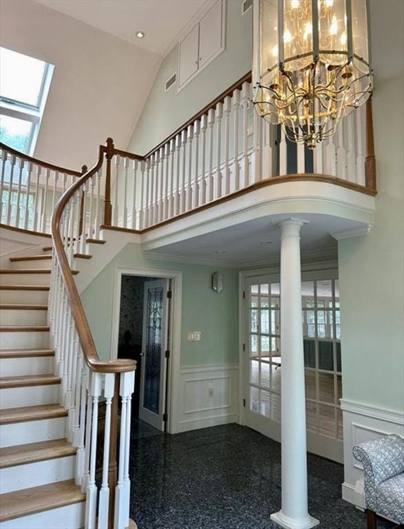 14 Alderbrook Dr, Topsfield, MA 01983 - staircase with high vaulted ceiling, a decorative wall, wainscoting, decorative columns, and a skylight