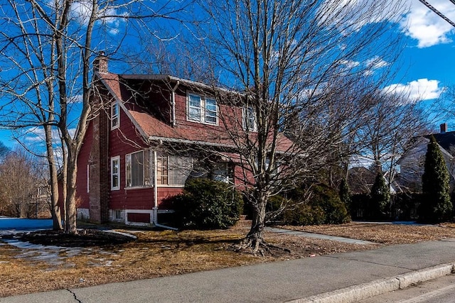 view of property exterior with a chimney