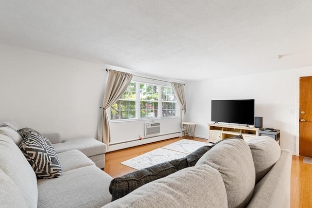 9 Tara Dr Unit 8, Weymouth, MA 02188 - living room featuring wood finished floors, a baseboard radiator, and a wall unit AC