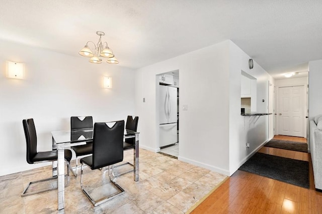 9 Tara Dr Unit 8, Weymouth, MA 02188 - dining area with a chandelier, baseboards, and wood finished floors