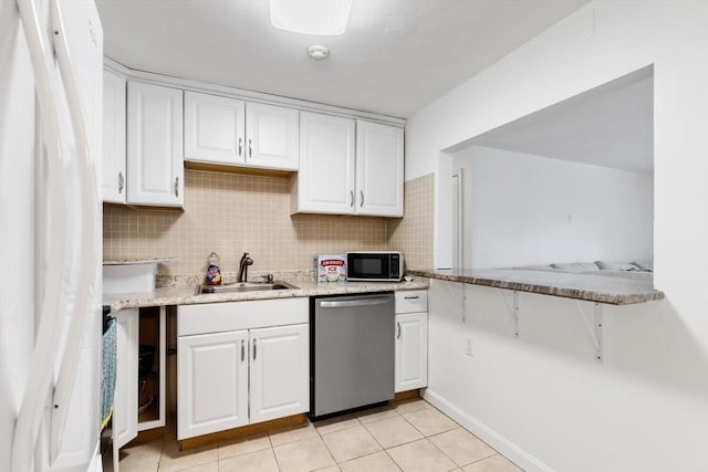 9 Tara Dr Unit 8, Weymouth, MA 02188 - kitchen featuring stainless steel dishwasher, freestanding refrigerator, black microwave, white cabinetry, and a sink