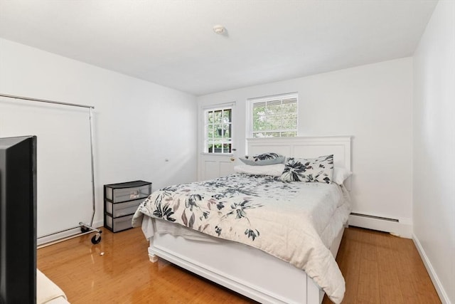 9 Tara Dr Unit 8, Weymouth, MA 02188 - bedroom featuring a baseboard radiator, wood finished floors, and baseboards