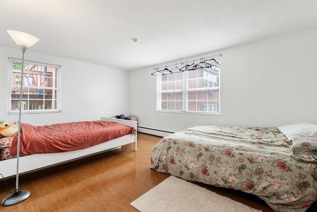 9 Tara Dr Unit 8, Weymouth, MA 02188 - bedroom featuring a baseboard radiator and wood finished floors
