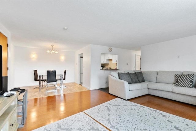 9 Tara Dr Unit 8, Weymouth, MA 02188 - living room featuring a chandelier and light wood-type flooring