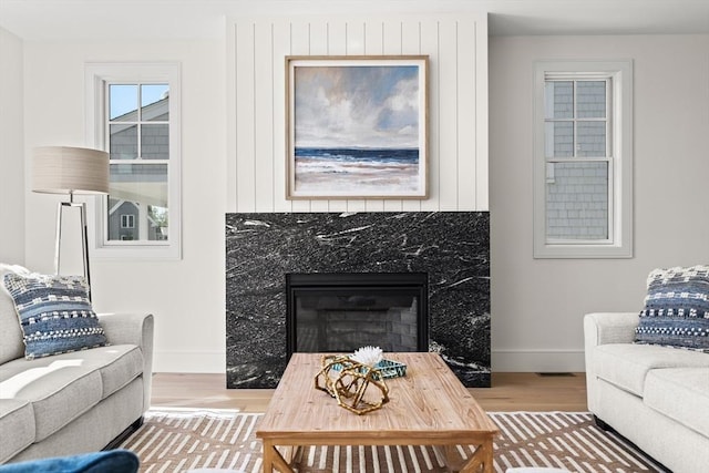 2 Collier Rd, Scituate, MA 02066 - living room featuring wood finished floors, baseboards, and a high end fireplace