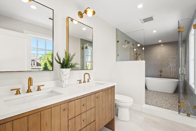 2 Collier Rd, Scituate, MA 02066 - bathroom featuring a freestanding tub, double vanity, toilet, tiled shower, and recessed lighting