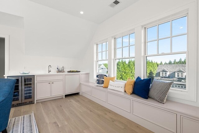 2 Collier Rd, Scituate, MA 02066 - indoor wet bar featuring beverage cooler, vaulted ceiling, light wood-style flooring, and recessed lighting