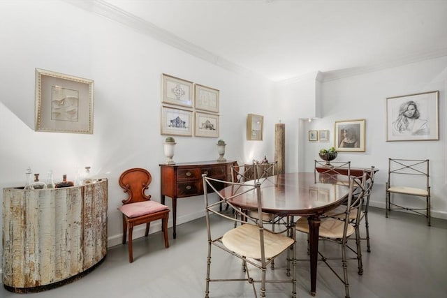 dining room featuring crown molding and concrete floors