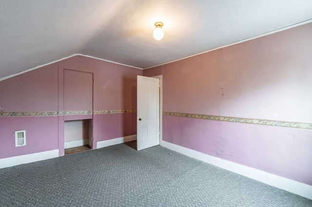 additional living space featuring carpet flooring, vaulted ceiling, and baseboards
