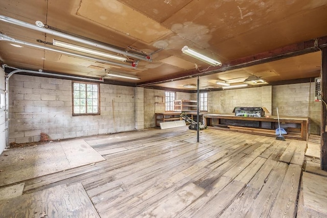 basement featuring hardwood / wood-style flooring and concrete block wall