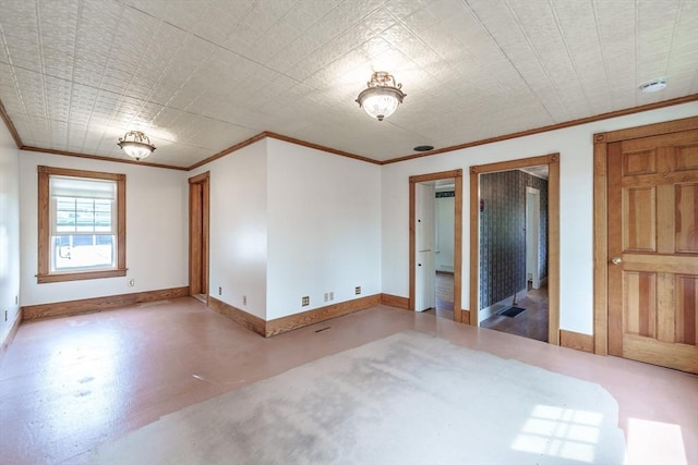 unfurnished bedroom featuring baseboards, crown molding, and concrete flooring