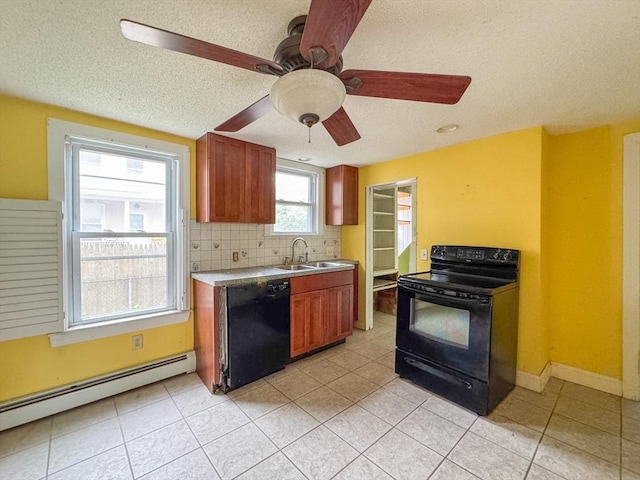 66 Taylor St, Holyoke, MA 01040 - kitchen featuring black appliances, a baseboard radiator, a textured ceiling, a sink, and light tile patterned floors