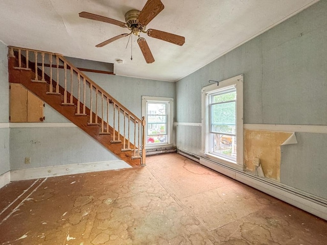 66 Taylor St, Holyoke, MA 01040 - unfurnished living room featuring a baseboard radiator, stairway, and a ceiling fan