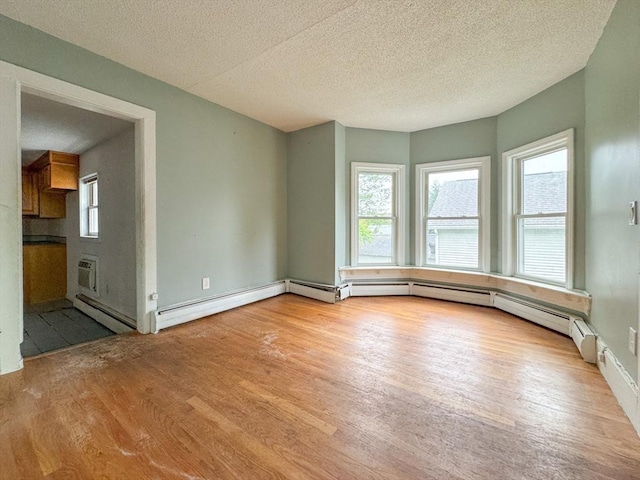 66 Taylor St, Holyoke, MA 01040 - unfurnished room with wood finished floors, a textured ceiling, and baseboards