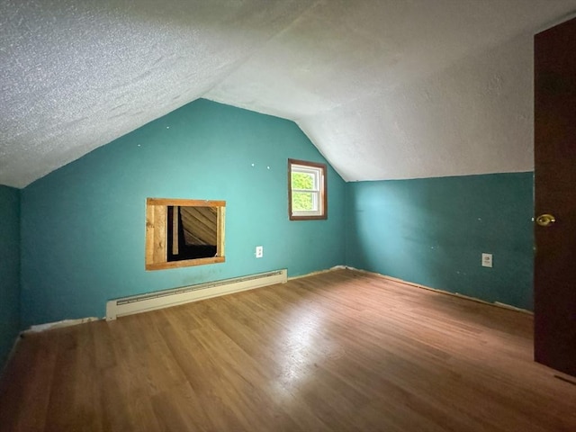 66 Taylor St, Holyoke, MA 01040 - bonus room with a baseboard radiator, wood finished floors, lofted ceiling, and a textured ceiling