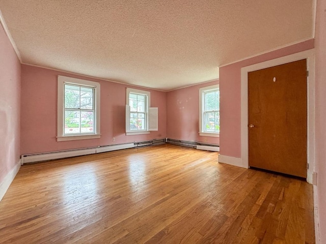 66 Taylor St, Holyoke, MA 01040 - unfurnished room featuring wood finished floors, healthy amount of natural light, a textured ceiling, baseboards, and crown molding