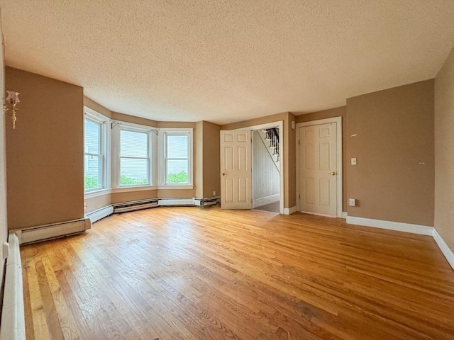 66 Taylor St, Holyoke, MA 01040 - unfurnished bedroom featuring a textured ceiling, wood finished floors, and baseboards