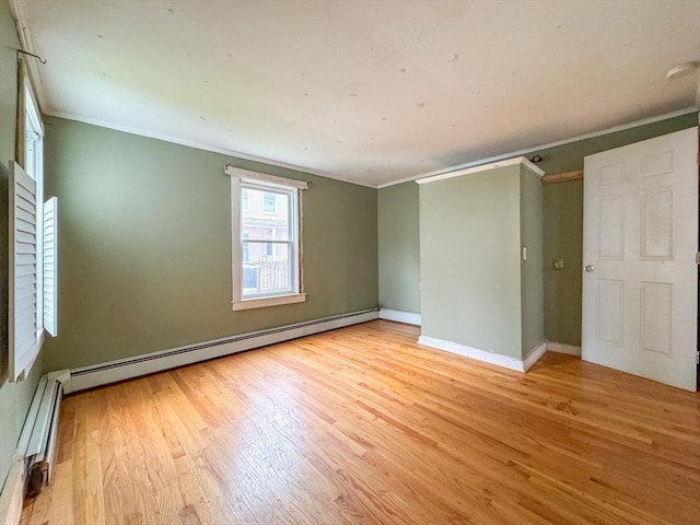 66 Taylor St, Holyoke, MA 01040 - empty room featuring ornamental molding, light wood-style floors, a baseboard heating unit, baseboards, and baseboard heating