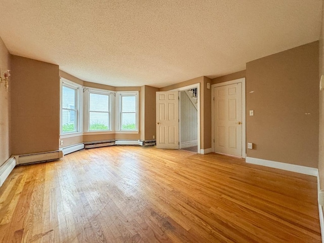 66 Taylor St, Holyoke, MA 01040 - unfurnished bedroom featuring a textured ceiling, light wood-type flooring, and baseboards