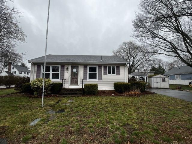 4 Yale St, Attleboro, MA 02703 - view of front of house with an outdoor structure, a storage unit, and a front lawn