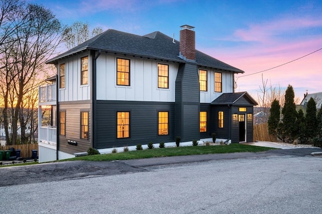 238 Bellevue St Unit 2, Newton, MA 02458 - view of front of home with a chimney, board and batten siding, a balcony, and a shingled roof