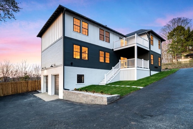 238 Bellevue St Unit 2, Newton, MA 02458 - view of front of property featuring an attached garage, board and batten siding, asphalt driveway, stairway, and a balcony