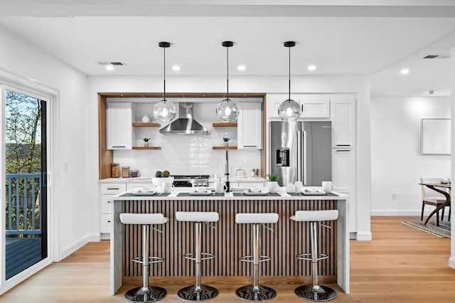 238 Bellevue St Unit 2, Newton, MA 02458 - kitchen with wall chimney exhaust hood, stainless steel fridge with ice dispenser, open shelves, white cabinetry, and decorative backsplash