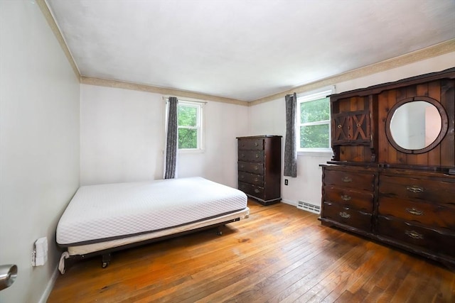 213 Nashua Rd, Billerica, MA 01862 - bedroom with wood-type flooring, multiple windows, and a baseboard radiator