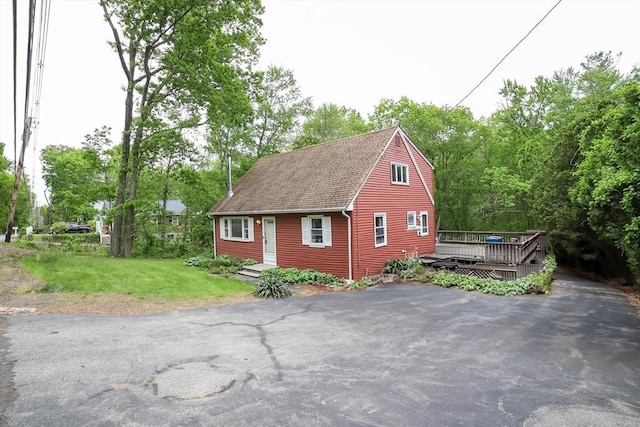 213 Nashua Rd, Billerica, MA 01862 - view of property exterior featuring a wooden deck, a shingled roof, and a yard