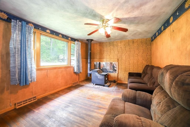 213 Nashua Rd, Billerica, MA 01862 - living room featuring hardwood / wood-style flooring, ceiling fan, and a wood stove