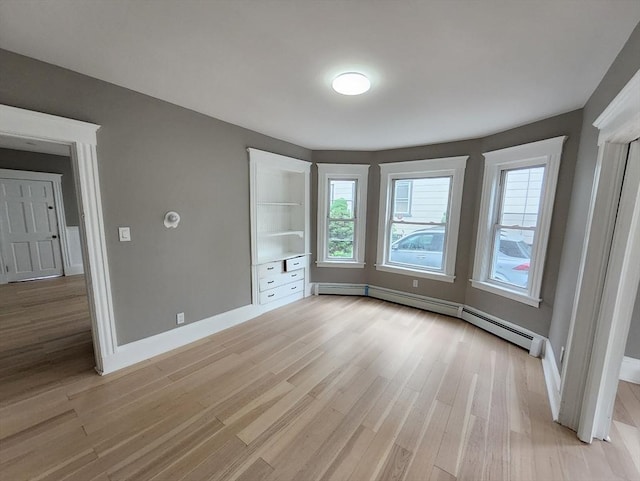 97-99 Blaisdell St Unit 1, Haverhill, MA 01832 - unfurnished bedroom with light wood-style floors, a baseboard heating unit, and baseboards