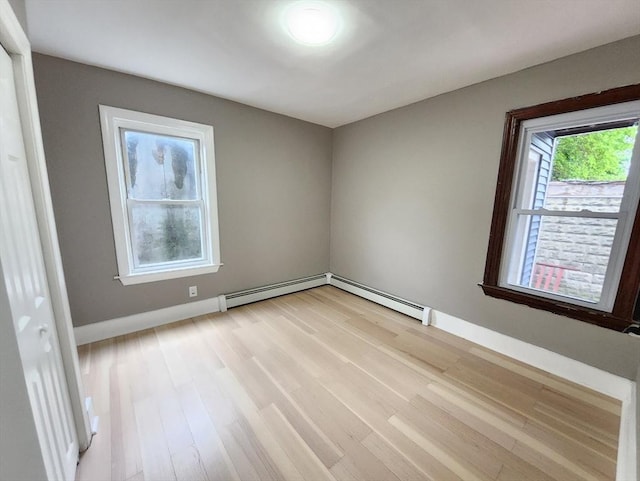 97-99 Blaisdell St Unit 1, Haverhill, MA 01832 - spare room with light wood-type flooring, a baseboard heating unit, and baseboards