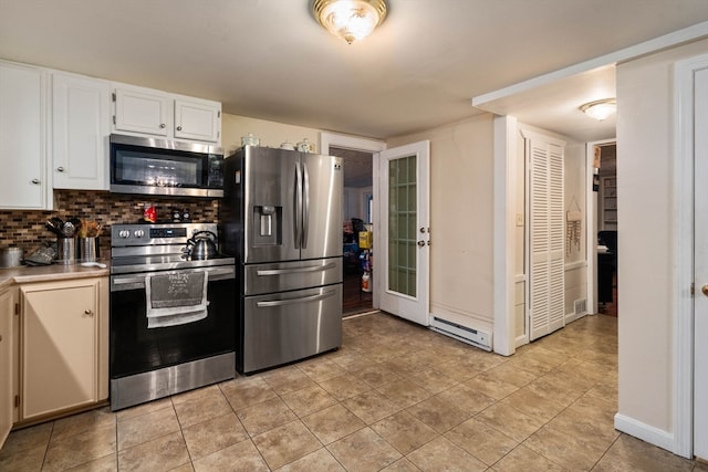 kitchen with white cabinetry, backsplash, appliances with stainless steel finishes, and light tile patterned floors