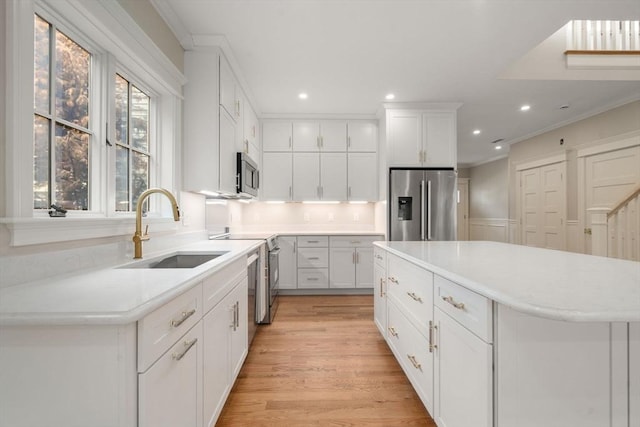 23 Francis Unit 23, Newton, MA 02459 - kitchen featuring appliances with stainless steel finishes, a sink, recessed lighting, white cabinets, and light wood-style floors