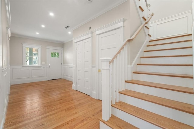 23 Francis Unit 23, Newton, MA 02459 - foyer featuring ornamental molding, a decorative wall, stairs, light wood-style flooring, and recessed lighting