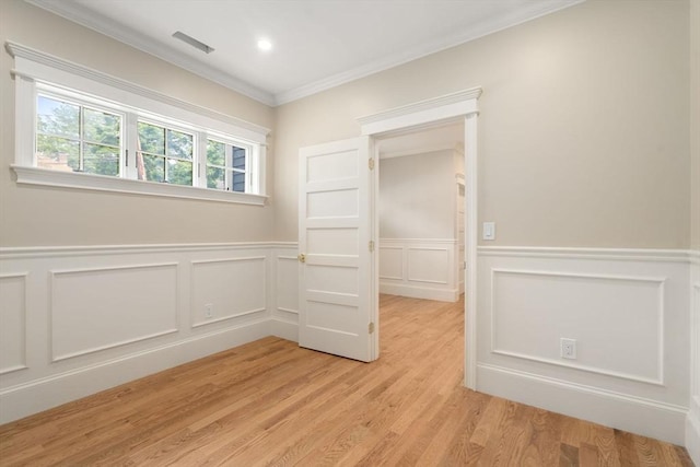 23 Francis Unit 23, Newton, MA 02459 - unfurnished room featuring ornamental molding, light wood-type flooring, a decorative wall, and wainscoting