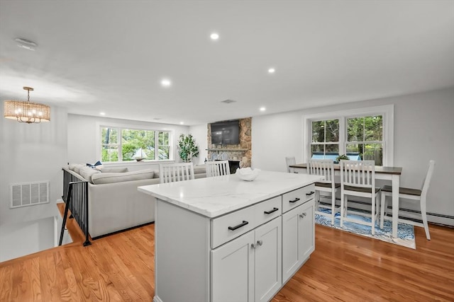 3 Laurie, Harwich, MA 02646 - kitchen with open floor plan, light wood finished floors, a stone fireplace, a kitchen island, and recessed lighting