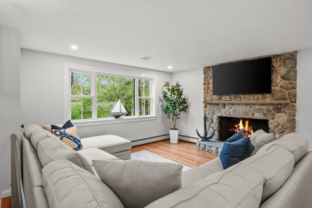 3 Laurie, Harwich, MA 02646 - living area with wood finished floors, a stone fireplace, a baseboard radiator, and recessed lighting
