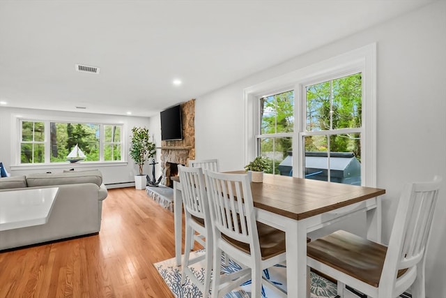 3 Laurie, Harwich, MA 02646 - dining space featuring light wood-type flooring, baseboard heating, a fireplace, and recessed lighting